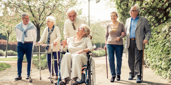 seniors with mobility aids walking in the park